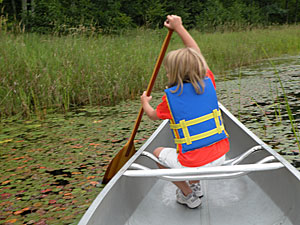 Girl paddling canoe